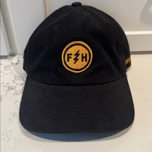 Fasthouse Women Black and Gold Boot Logo Trucker Hat.